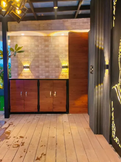 A close-up of the Buddha art panel and custom cabinetry in the covered seating area of the Uttam Nagar project.