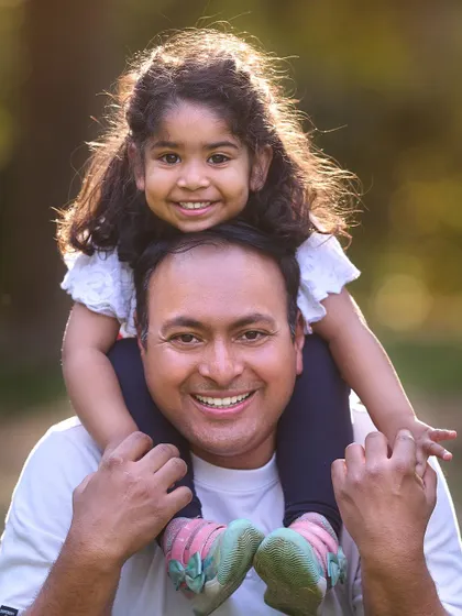 The special bond between a father and his daughter. This close-up shot, filled with sunshine and smiles, is a perfect keepsake from a family photoshoot.