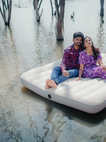 A candid moment of relaxation and affection during the unique lake mattress shoot. It shows the couple's comfortable love.