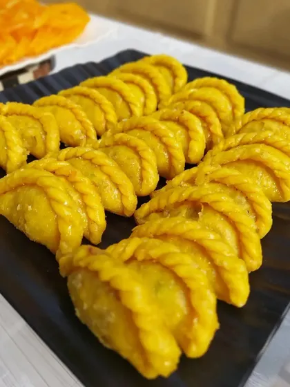 A platter of perfectly pleated gujiyas ready to be served at a corporate Holi party. We pay close attention to the quality and authenticity of our festive food offerings.