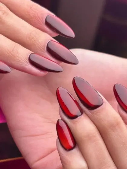 Another look at the stunning red jelly nails, showing how they catch the light to reveal their depth and glossy finish.