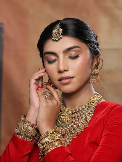 A close-up of the eye makeup for this regal look. The soft, shimmery tones and winged liner create a timeless and elegant effect.