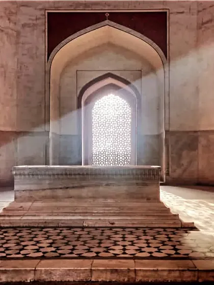 The cenotaph of Emperor Humayun, with light streaming through a jali screen. The actual grave lies in a chamber below. We discuss the symbolism and design of Mughal funerary architecture here.