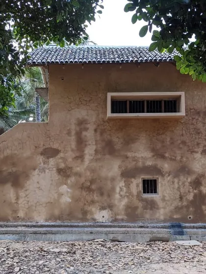 The rustic exterior of the Hassan farmhouse, with its earthy tones and traditional form, feels rooted in its location.