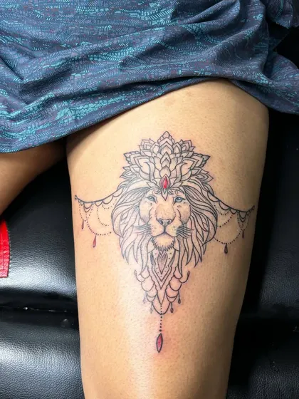 A lioness is still a queen. This ornamental lion tattoo on the thigh is a popular design for women who want to represent their strength and independence.