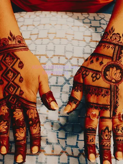 For a unique back-of-hand design, I combine different elements like geometric patterns, lotus motifs, and jewellery-style chains. This creates a stylish and unconventional look.
