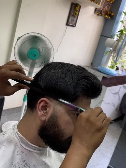 Scissor work is just as important as clipper work. Here I'm using my shears to texturize and shape the top.