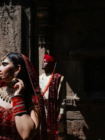 A portrait that plays with light and shadow within the stunning architecture of a heritage site. The bride is illuminated while the groom remains in the shadows, creating a sense of depth and mystery in this cinematic couple shot.