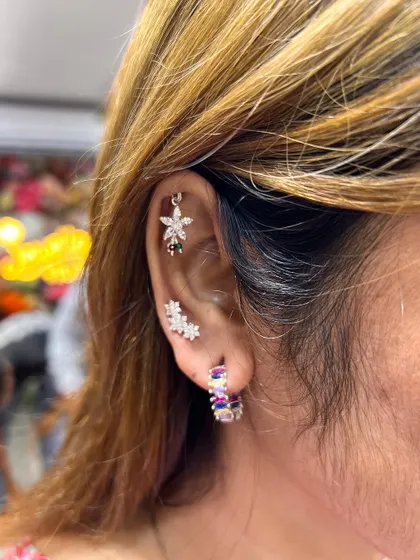 A vibrant and colorful ear stack. We combined multi-colored floral studs with sparkling hoops to create a look that is full of personality and joy.