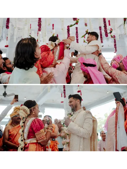 A dynamic shot of the groom being lifted by his friends during the varmala (garland exchange) ceremony, a fun and competitive tradition.