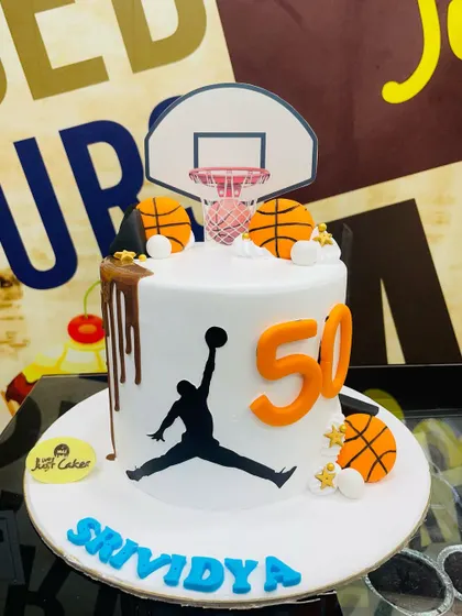 A 1.5kg basketball cake for a 50th birthday, featuring the Jordan silhouette and a hoop.