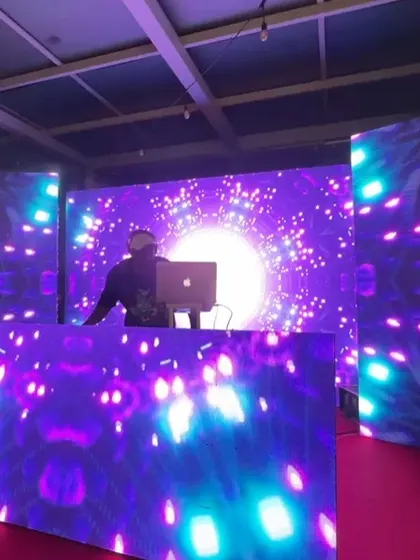 My silhouette against a massive LED wall with cosmic visuals at the brewery event.