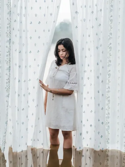 A moment of peace. Our sheer curtains, with their subtle print, create a beautiful, diffused light, perfect for this serene scene by the water.
