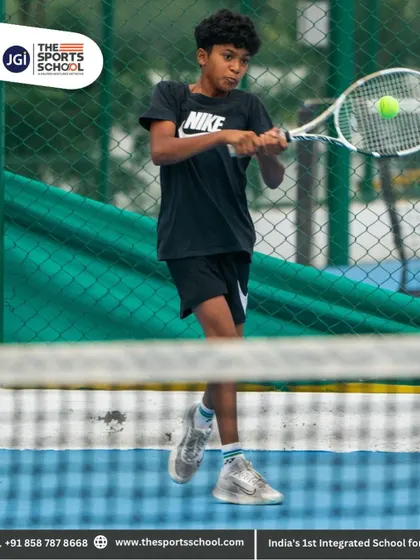 A young player hits a two-handed backhand with perfect form, a testament to our technical coaching.