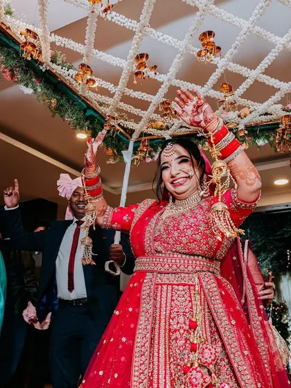 The bride's joyful entrance under a 'phoolon ki chadar', a moment of pure happiness and anticipation.