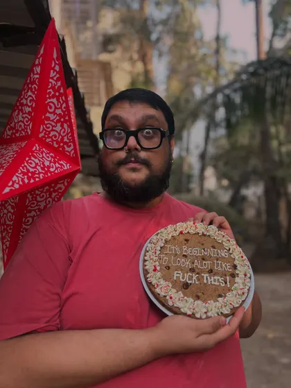 Just kidding, I'm not a Grinch! Here I am, holding my cheeky Christmas cookie. I truly love the festive chaos.