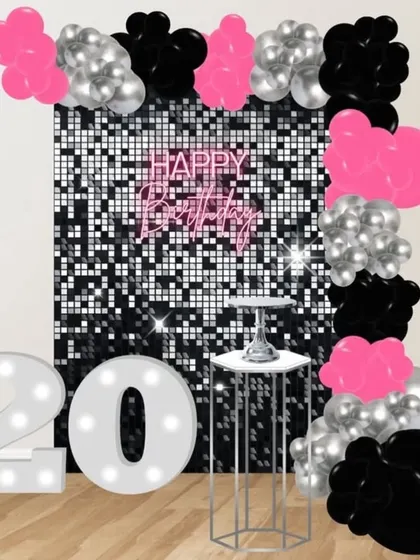 This mockup for a 20th birthday shows a glamorous disco theme with a black, pink, and silver color scheme and a sparkling backdrop.