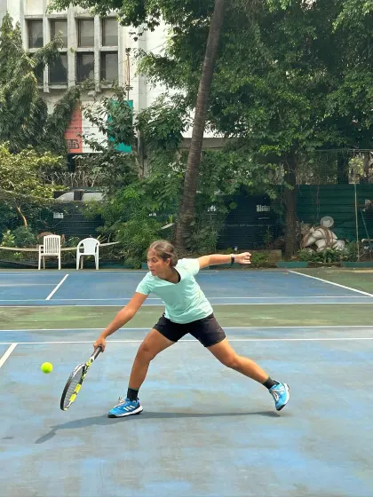 A female player lunges for a low forehand slice during the MSSA finals, capturing the determination of our athletes.