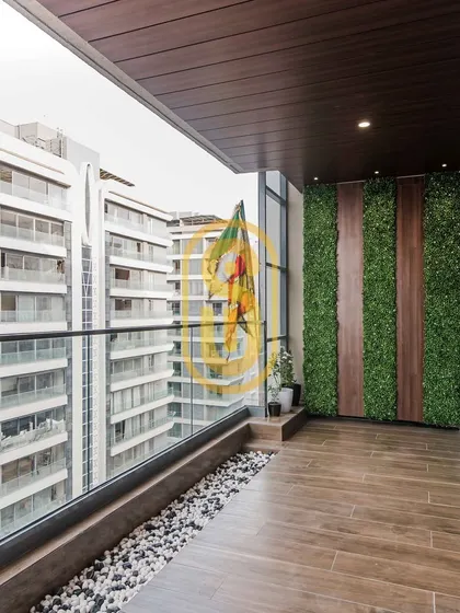This balcony is transformed into a green oasis with a vertical garden wall. The combination of wood, stone pebbles, and artificial turf creates a low-maintenance yet refreshing outdoor space.