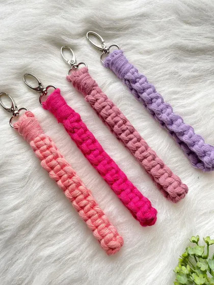 A set of macrame wristlet keychains in a beautiful gradient of pink and purple shades. These are perfect for keeping your keys handy and make a wonderful, colorful gift.
