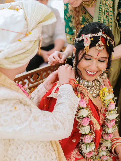 A joyful moment during the ceremony as the mangalsutra is tied, a key ritual in Hindu weddings.