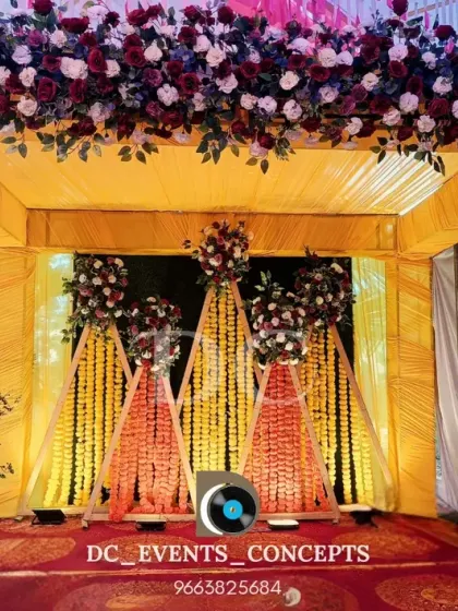 A traditional Haldi ceremony backdrop featuring pyramids of marigold flowers. The rich floral arrangements and yellow color scheme are perfect for this auspicious and joyful occasion.