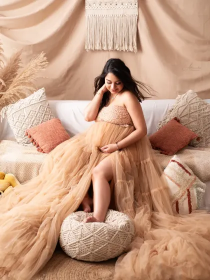 A beautiful solo shot on our comfortable boho sofa. The neutral tones of the gown and the set create a warm, earthy, and relaxed atmosphere.