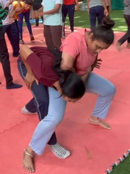 This image shows a practical takedown drill in progress on our safety mats. We create a secure space for participants to practice dynamic and physical techniques without fear of injury.