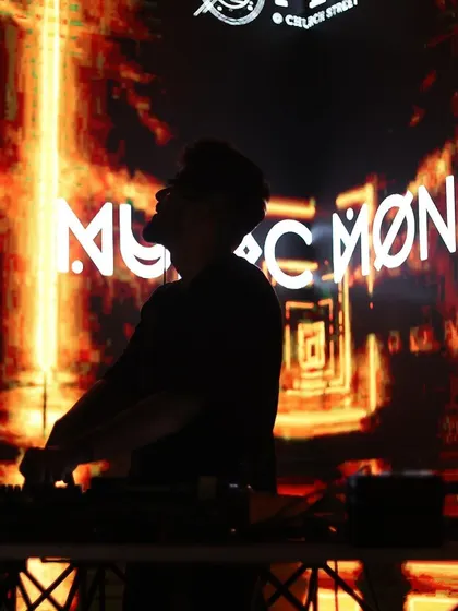 A silhouette of me against a fiery, abstract background with my logo. This artistic shot captures the intensity of the music.
