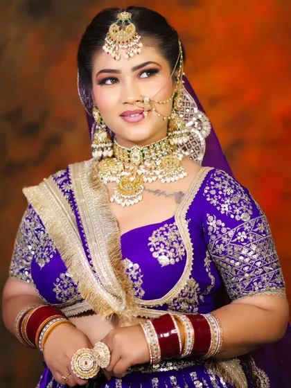 A full-view portrait that displays the student's skill in creating a complete, head-to-toe bridal look that is both grand and graceful.