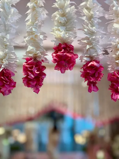 A beautifully focused shot on the hanging pink and white floral tassels. This highlights the texture and color palette I used to create a soft, romantic, and visually stunning entrance aisle.