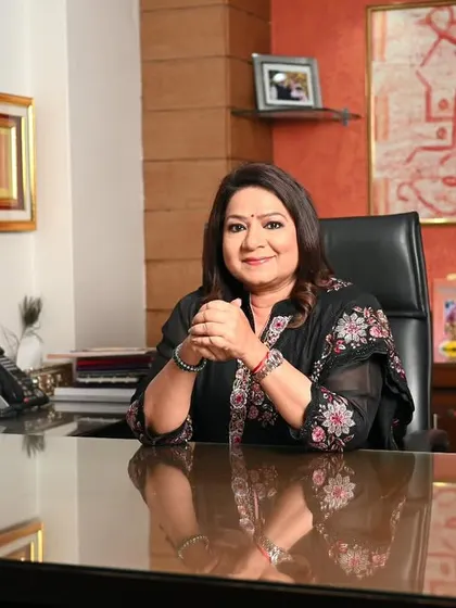 Capturing a moment of engagement at the desk. This shot of Mrs. Prasad feels authentic and active, as if in the middle of a productive day at the office.