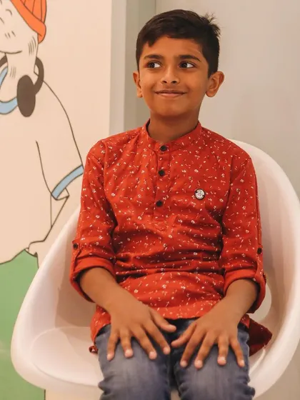 Aethen, sitting thoughtfully, represents the curious minds we nurture. From a "noob" on Zoom to a budding robotics engineer, his journey shows the power of hands-on learning.