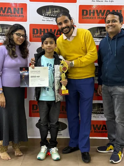 The winner with his proud parents and teacher. We believe in a collaborative approach, where teachers and parents work together to support a student's journey.