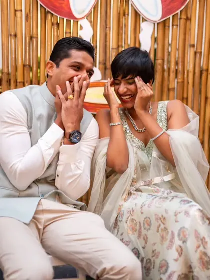 A candid shot of a couple sharing a laugh, showcasing their natural chemistry and the joy of their special day.
