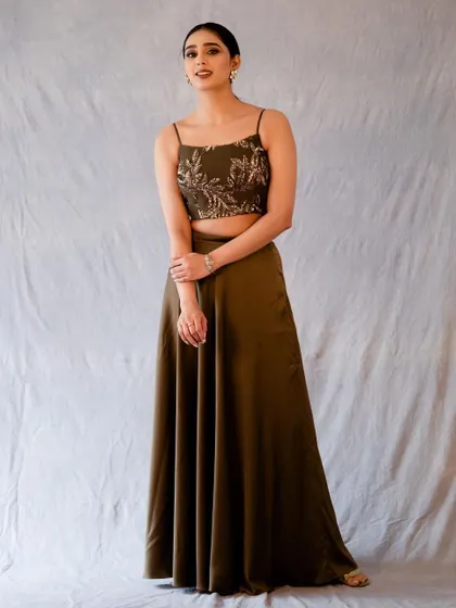 A more reserved pose in the same olive green outfit. This shows a softer, more elegant side.