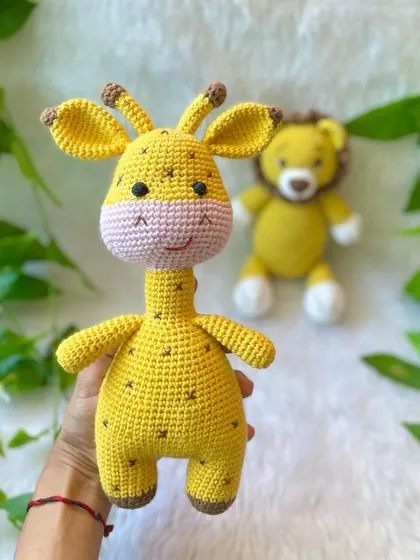 Holding the big, cheerful giraffe from the jungle friends set. I love his sweet smile and spotted pattern.