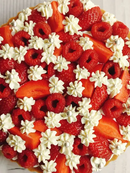 A celebration of freshness, this is my signature raspberry and strawberry cheesecake tart. I top a creamy, rich cheesecake base with a generous layer of fresh berries and delicate whipped cream dollops for a perfect balance of sweet and tart.