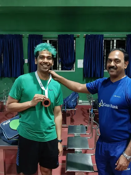 Back at the academy, Coach Krunal Telang congratulates Vikramadithya S on his international bronze medal win for Team India in Nepal.