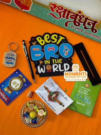This is my special Rakshabandhan combo for the 'Best Bro in the World'. It includes a tabletop sign, a pen, rakhi, keychain, and a small thali, all packed together for the perfect Rakhi gift.