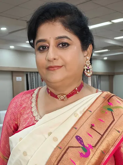 A beautiful, happy portrait of the mother of the bride. Her makeup is classic and elegant, with a lip color that complements her saree perfectly.