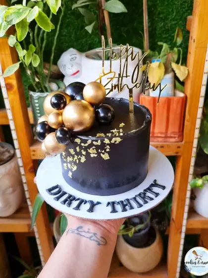 Talk Thirty to Me! A bold and fun "Dirty Thirty" cake in black and gold. It's a great way to celebrate a 30th birthday with style and a bit of humor.