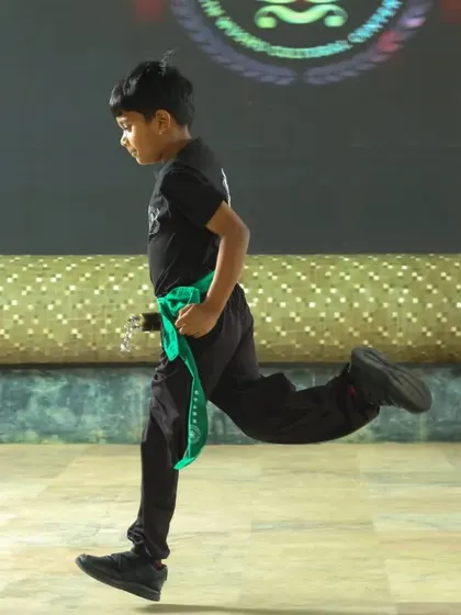 The grace and power of a running form, captured during our black belt ceremony. This showcases the athletic ability developed through consistent Wushu practice.