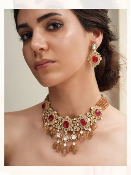 A regal polki necklace with deep red stones and delicate drops of semi-precious beads.