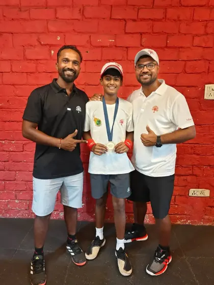 The coaching team celebrating with Rishikesh Mane after his silver medal performance for Team India. Our collaborative coaching approach ensures every player gets the support they need to reach their peak potential.