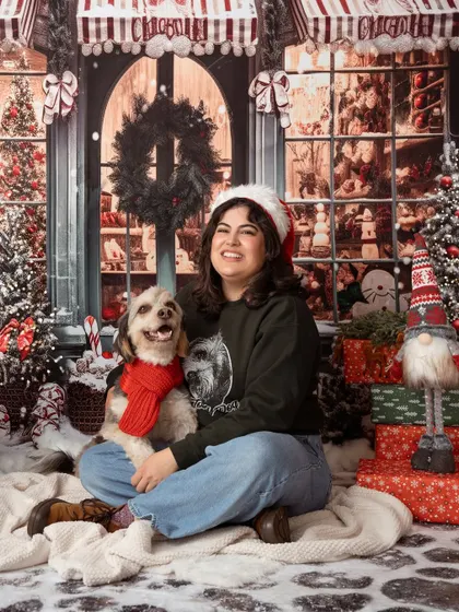 All smiles for this Christmas shoot! This woman and her happy dog, complete with a festive red scarf, look so joyful surrounded by our winter wonderland backdrop.