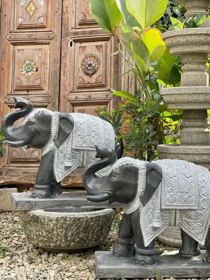 Our pair of grand elephant statues, with their trunks raised in a gesture of welcome, stand proudly at an entrance.