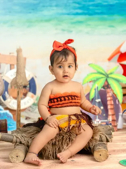 A Moana-inspired beach theme for a little girl, featuring character props and a tropical island vibe.