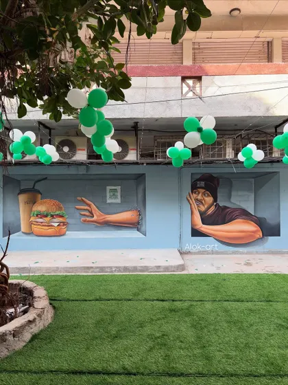 The cafe mural decorated with balloons for an event. It shows how the artwork becomes a versatile backdrop for the daily life and special occasions of the business.