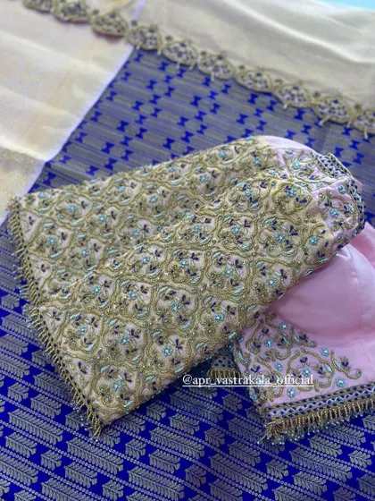 The sleeves of the lavender blouse, with dense floral embroidery.